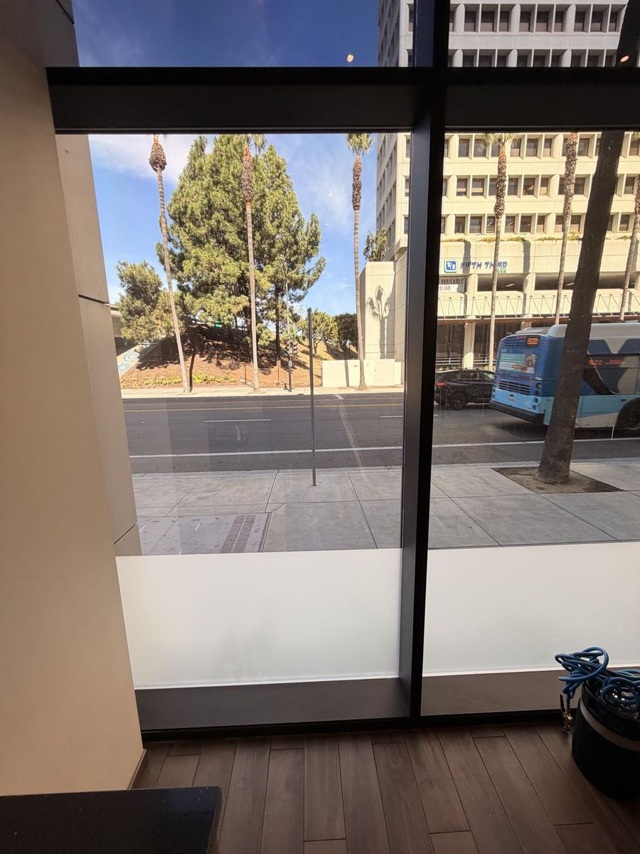 Frost privacy band wrapping a corner office in San Jose