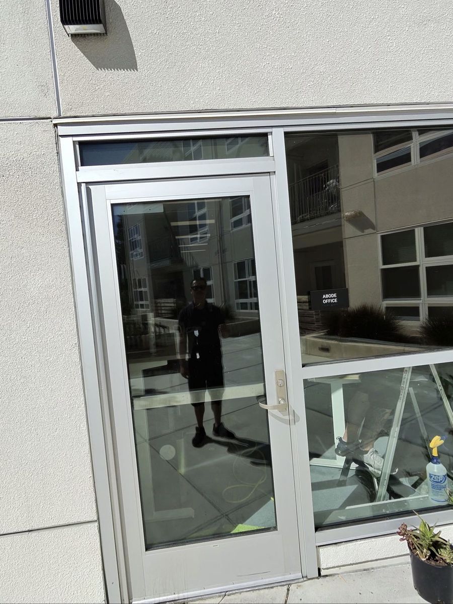 Installer working window film into place in a San Jose office